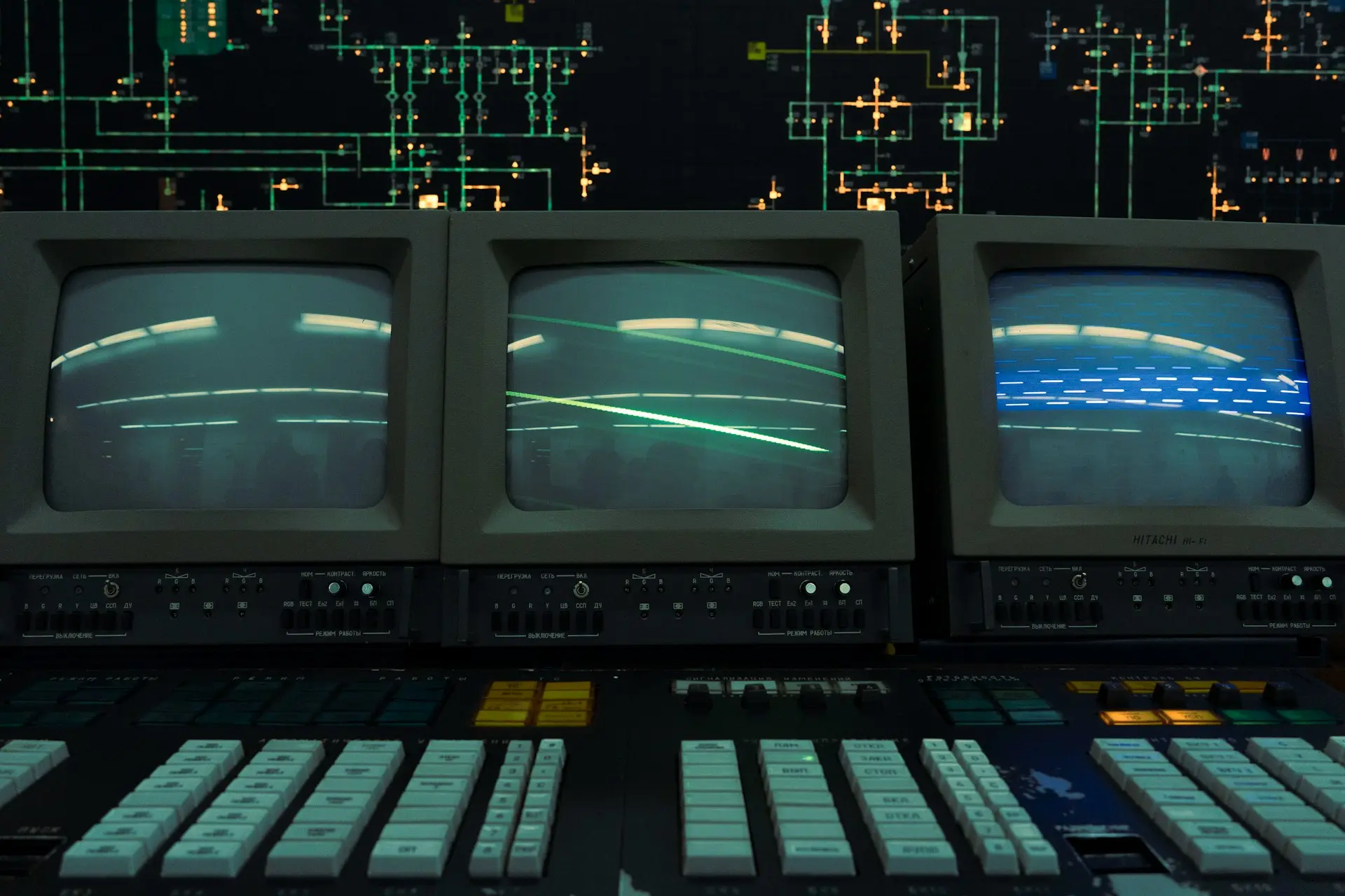 Three old crt monitors display a line.