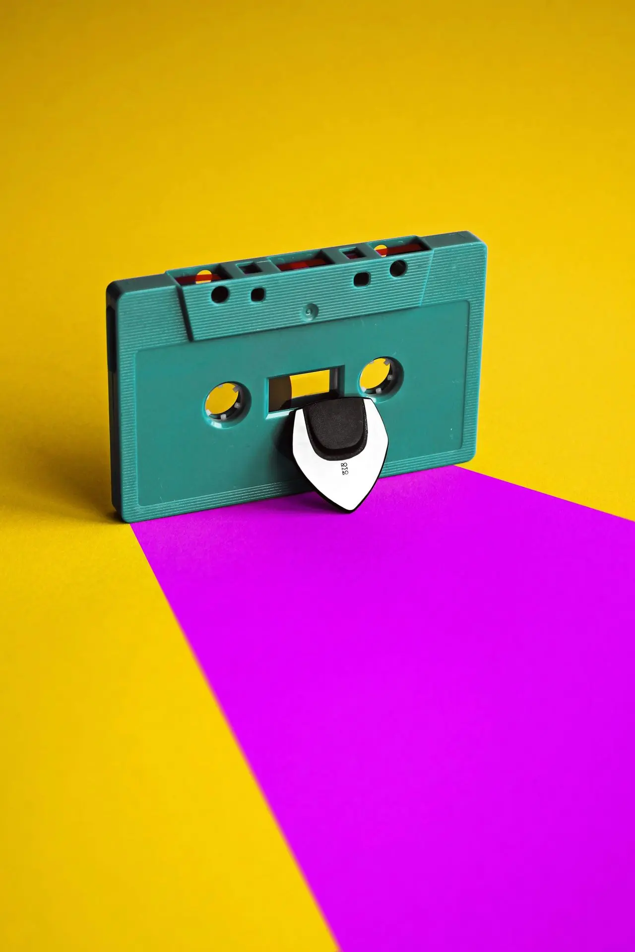 a tape dispenser sitting on top of a purple and yellow background